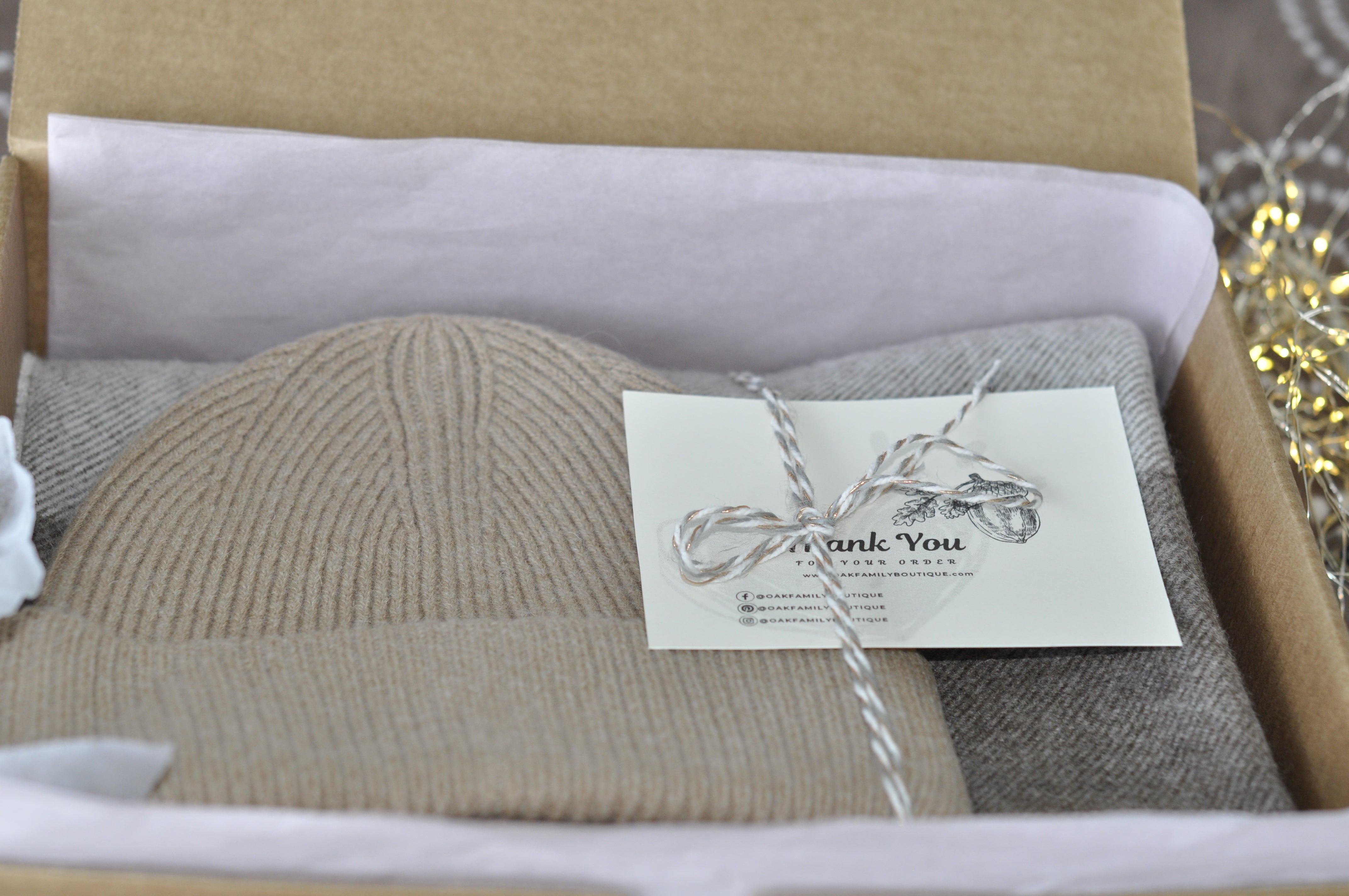 Knitted hat and scarf set in a box with a 'Thank You' card.
