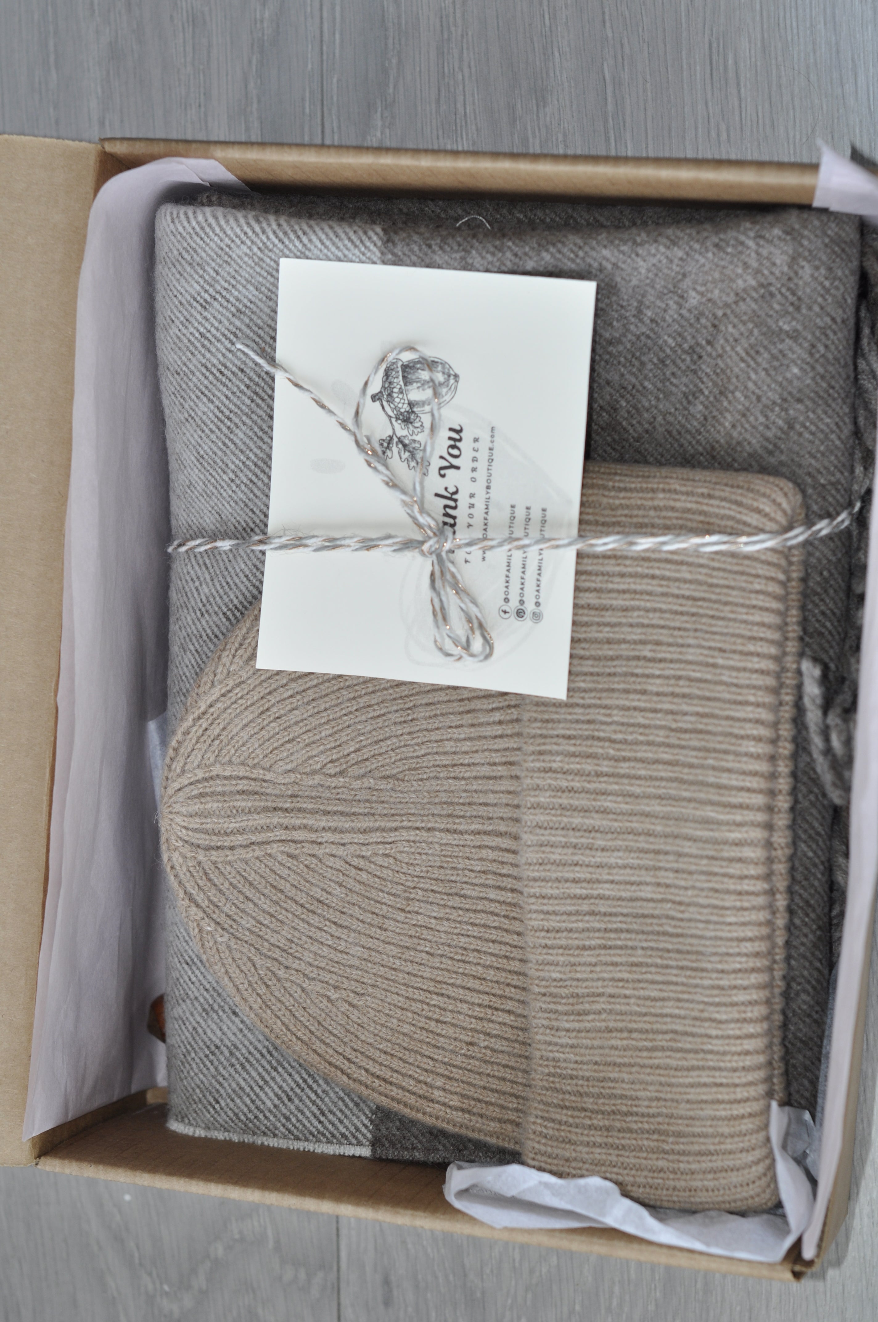 Knitted hat and scarf set in a box with a 'Thank You' card.