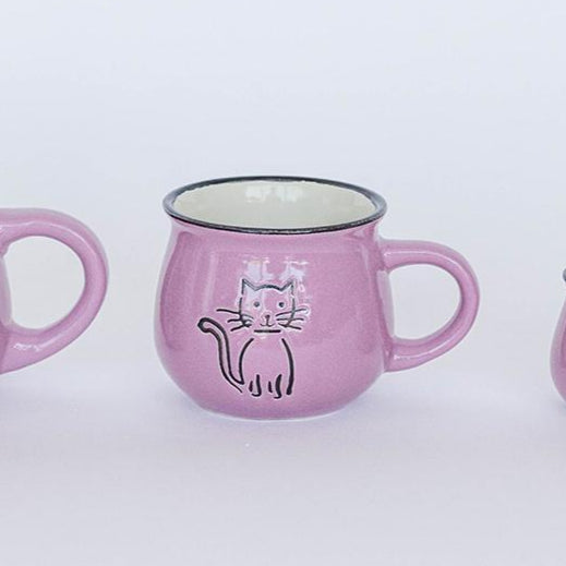 Three pink mugs with cat designs on a white background