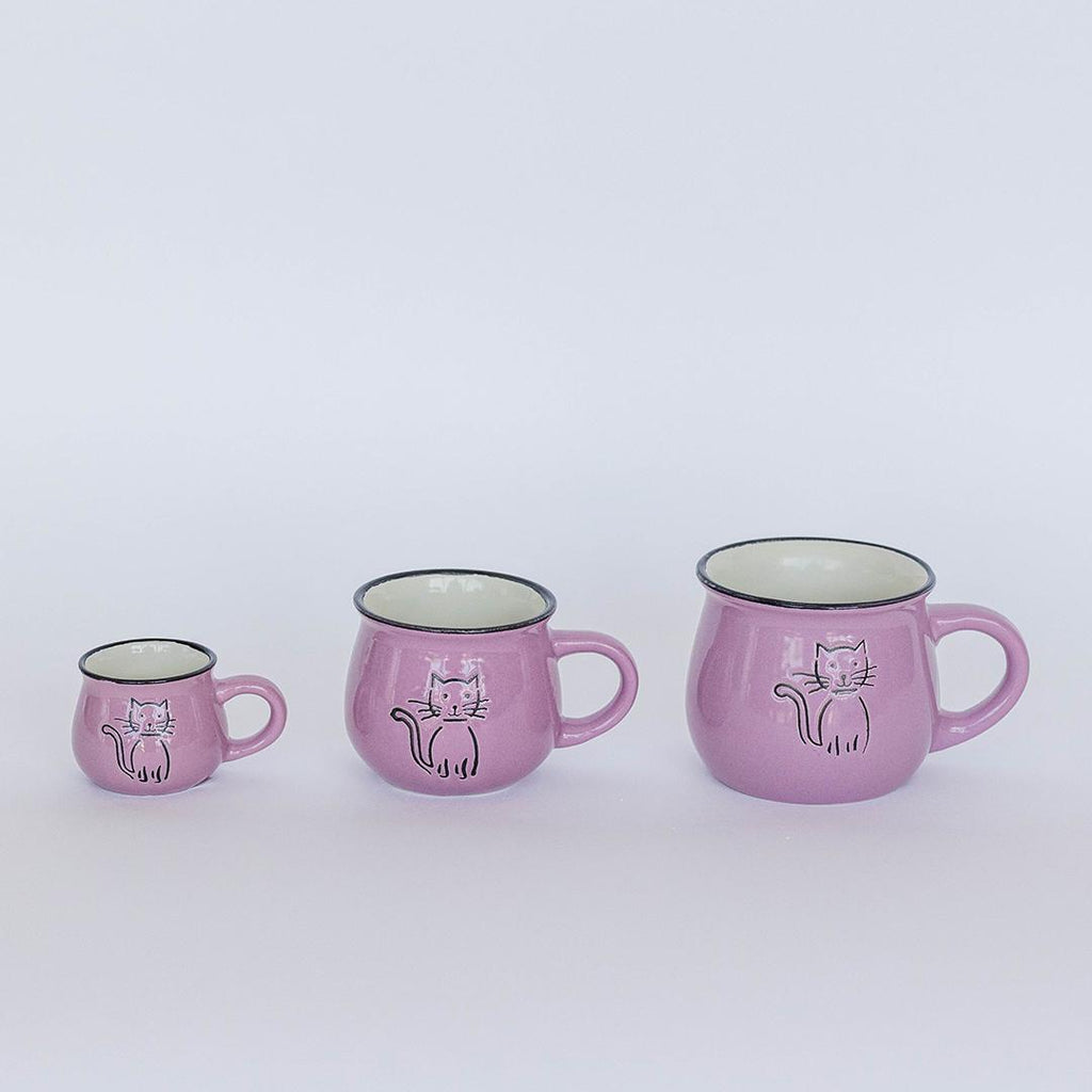 Set of three pink mugs with cat illustrations on a white background