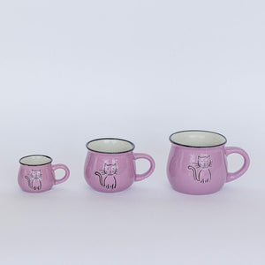 Set of three pink mugs with cat illustrations on a white background