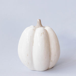 White ceramic pumpkin on a light gray background
