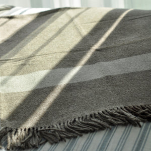 Striped blanket with frayed edge on a surface