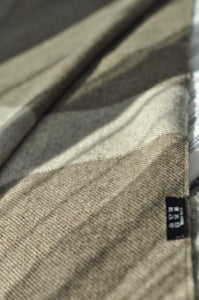 Close-up of a textured fabric with a label on a neutral background