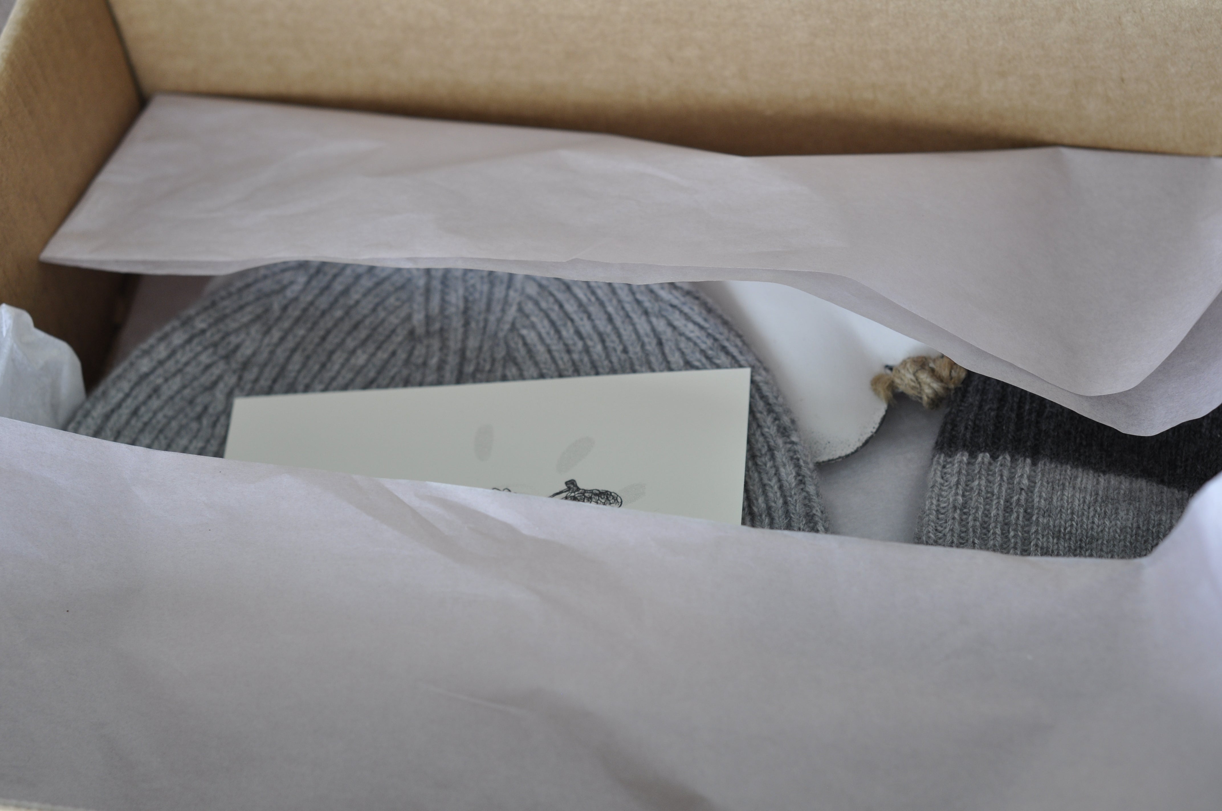 Box with a card and gray fabric inside