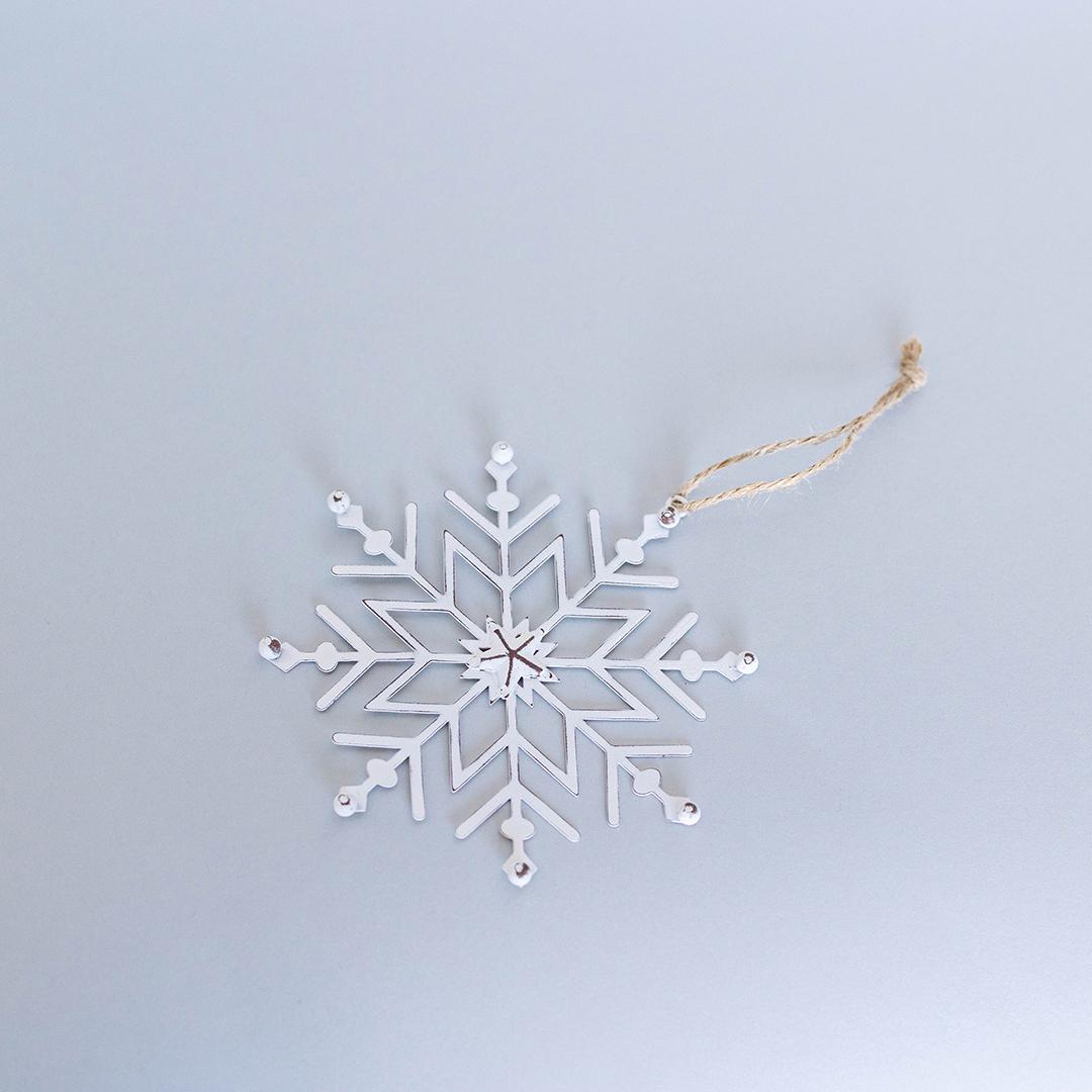 White snowflake ornament on a light gray background