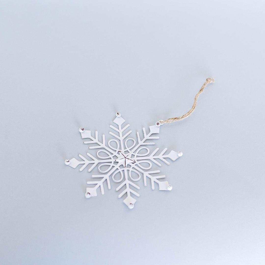 White snowflake ornament on a light blue background