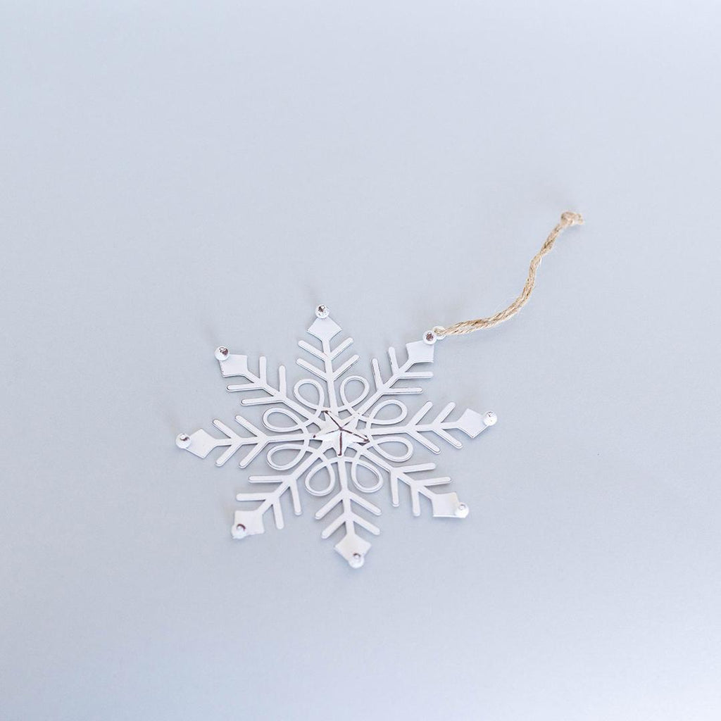 White snowflake ornament on a light blue background
