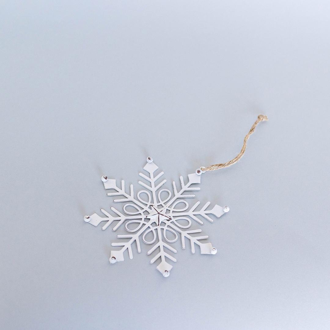 Decorative snowflake ornament on a light gray background