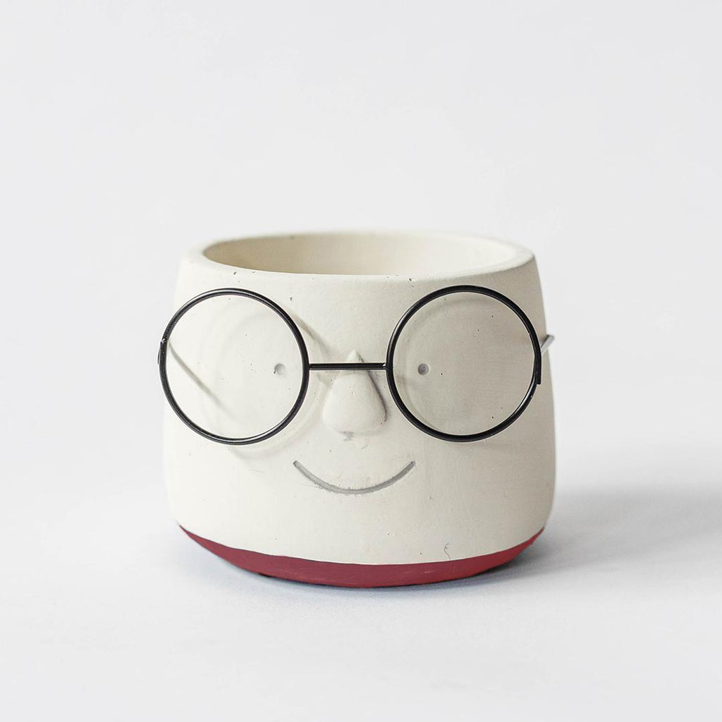 Ceramic pot designed like a face with glasses on a white background
Two ceramic pots with black eyeglasses on a wooden surface, perfect gifts for teachers