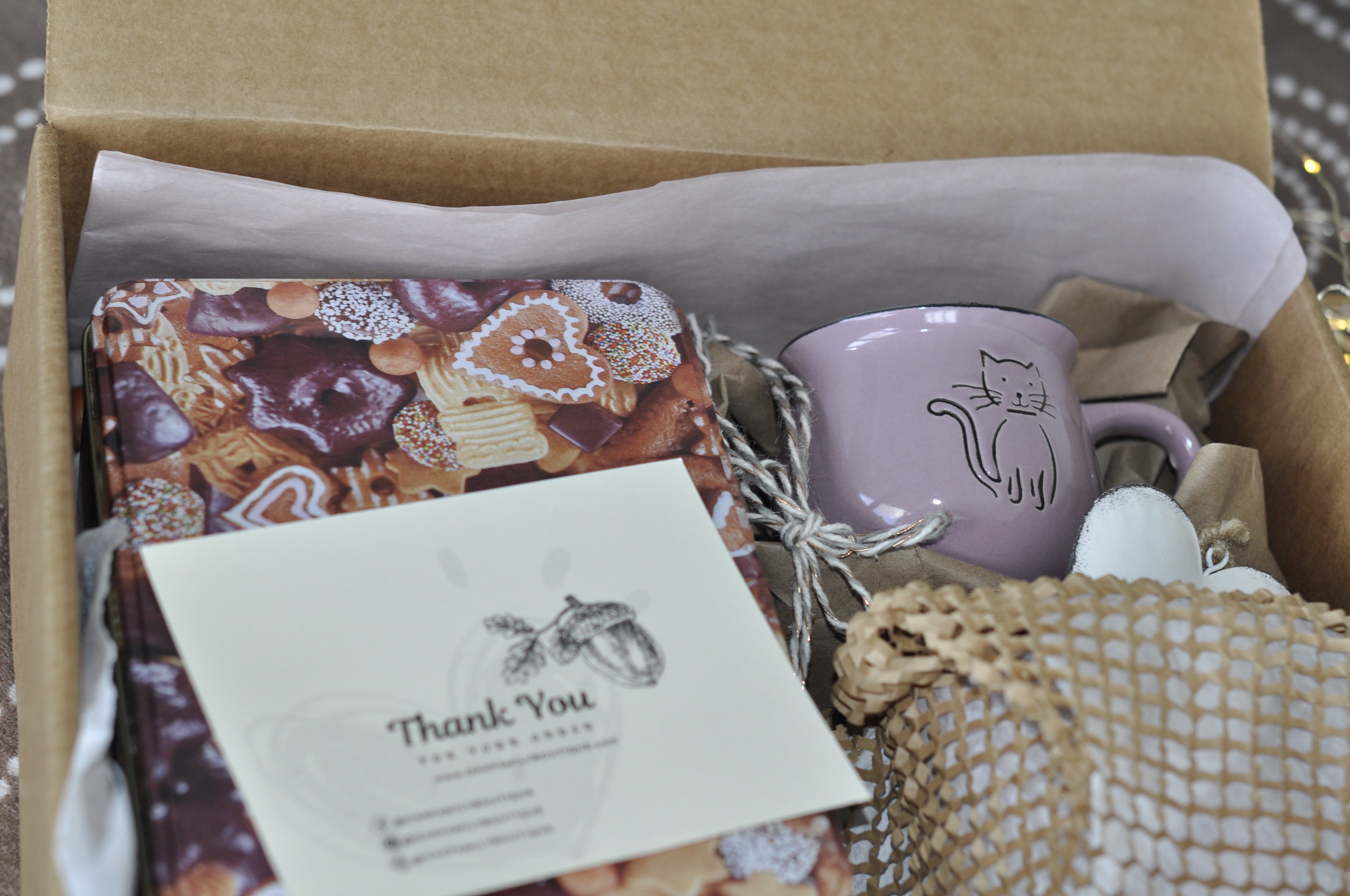 Gift box with a mug, notebook, and card inside