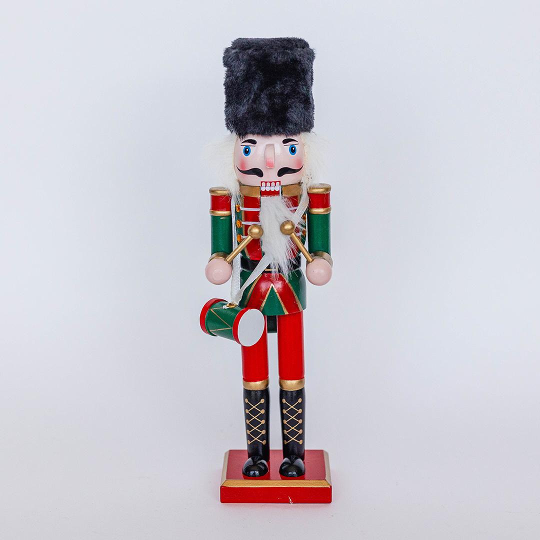 Decorative nutcracker figurine with a red and green uniform on a white background
