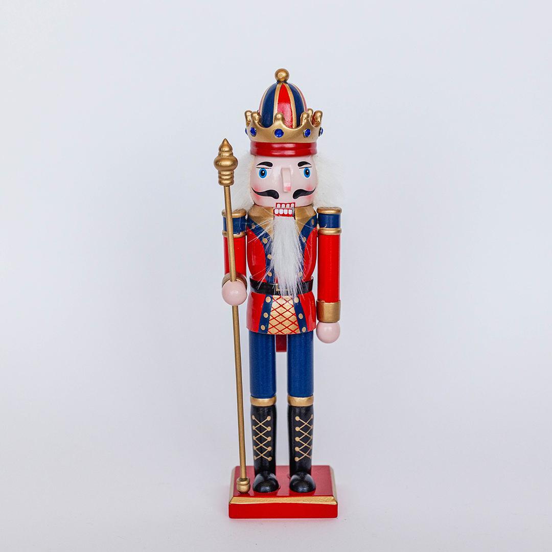 Decorative nutcracker figurine with a crown on a white background