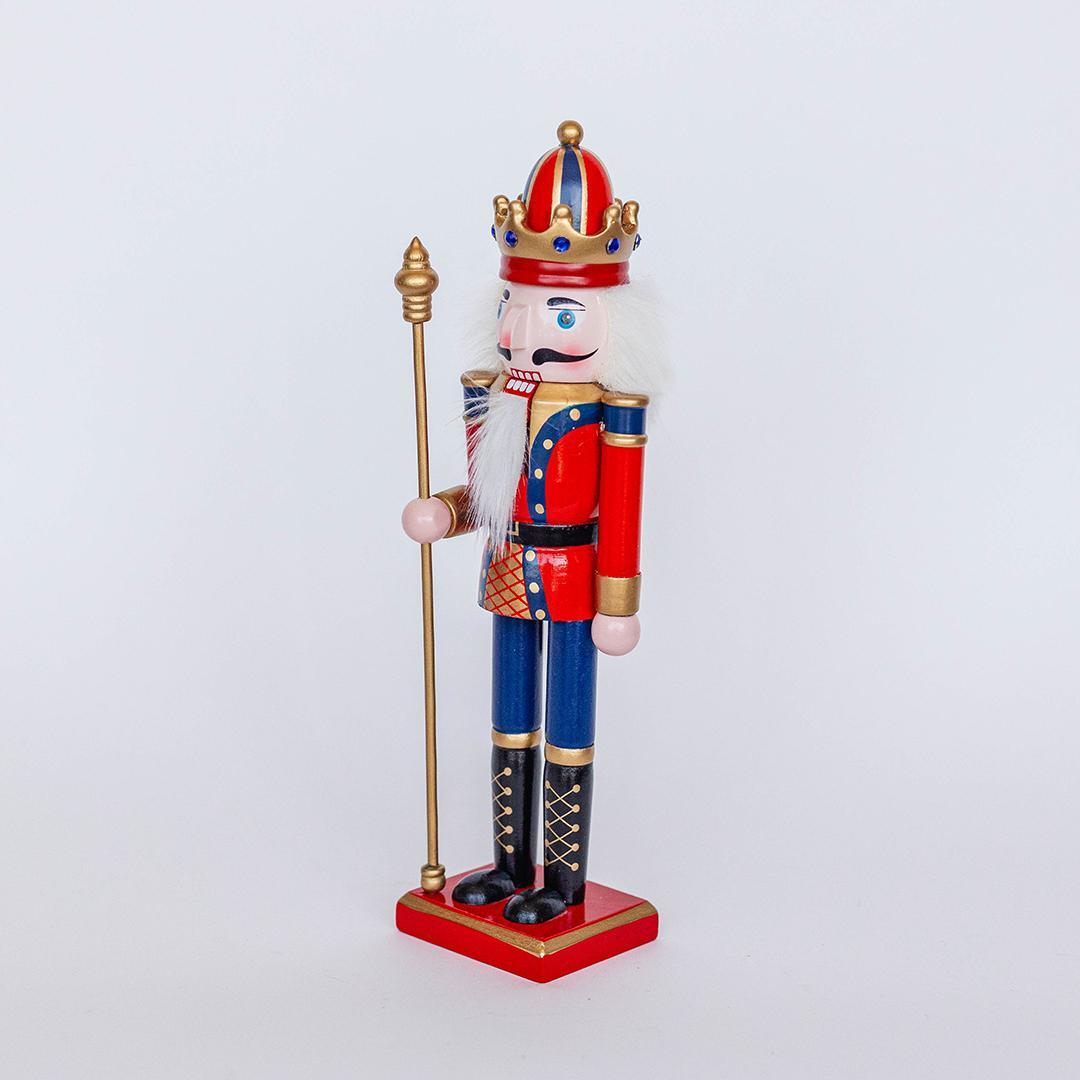 Decorative nutcracker figurine with a crown on a white background