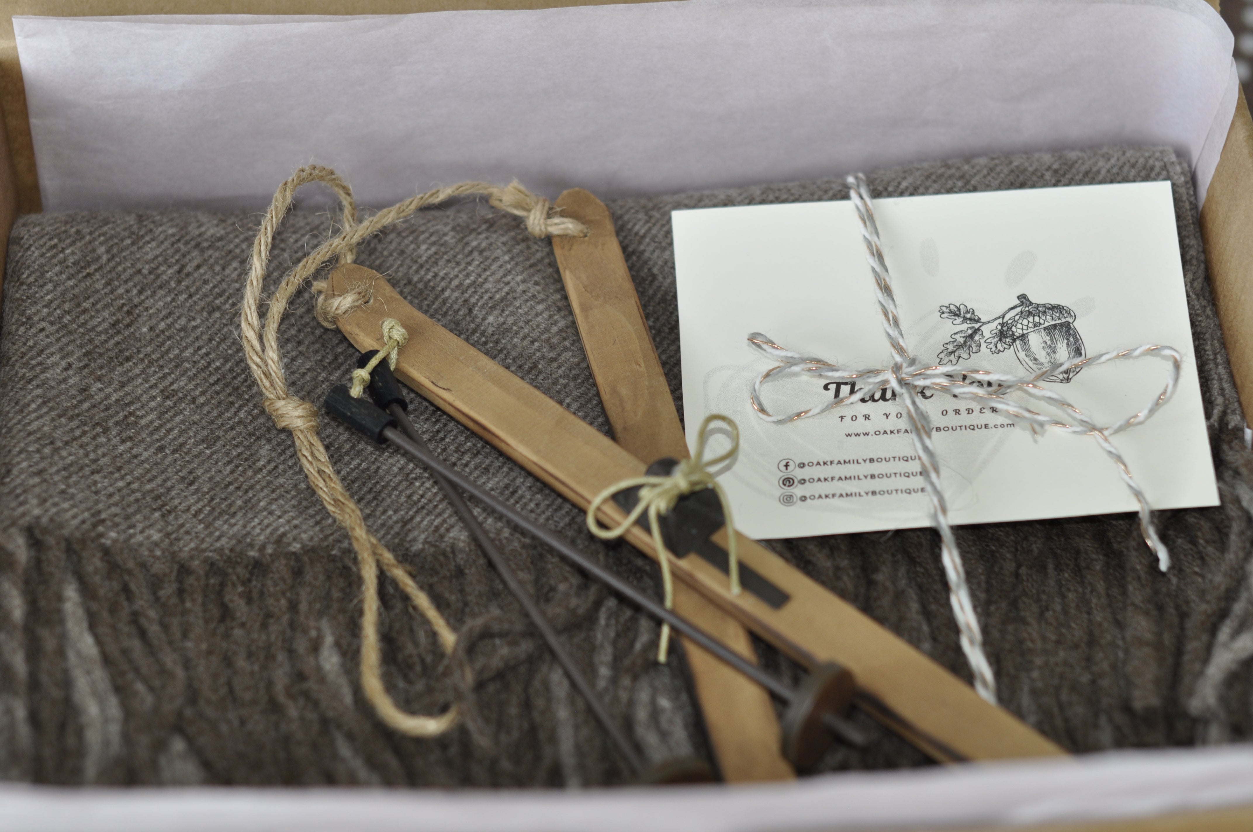 Wooden crossbow set with accessories and a business card in a box