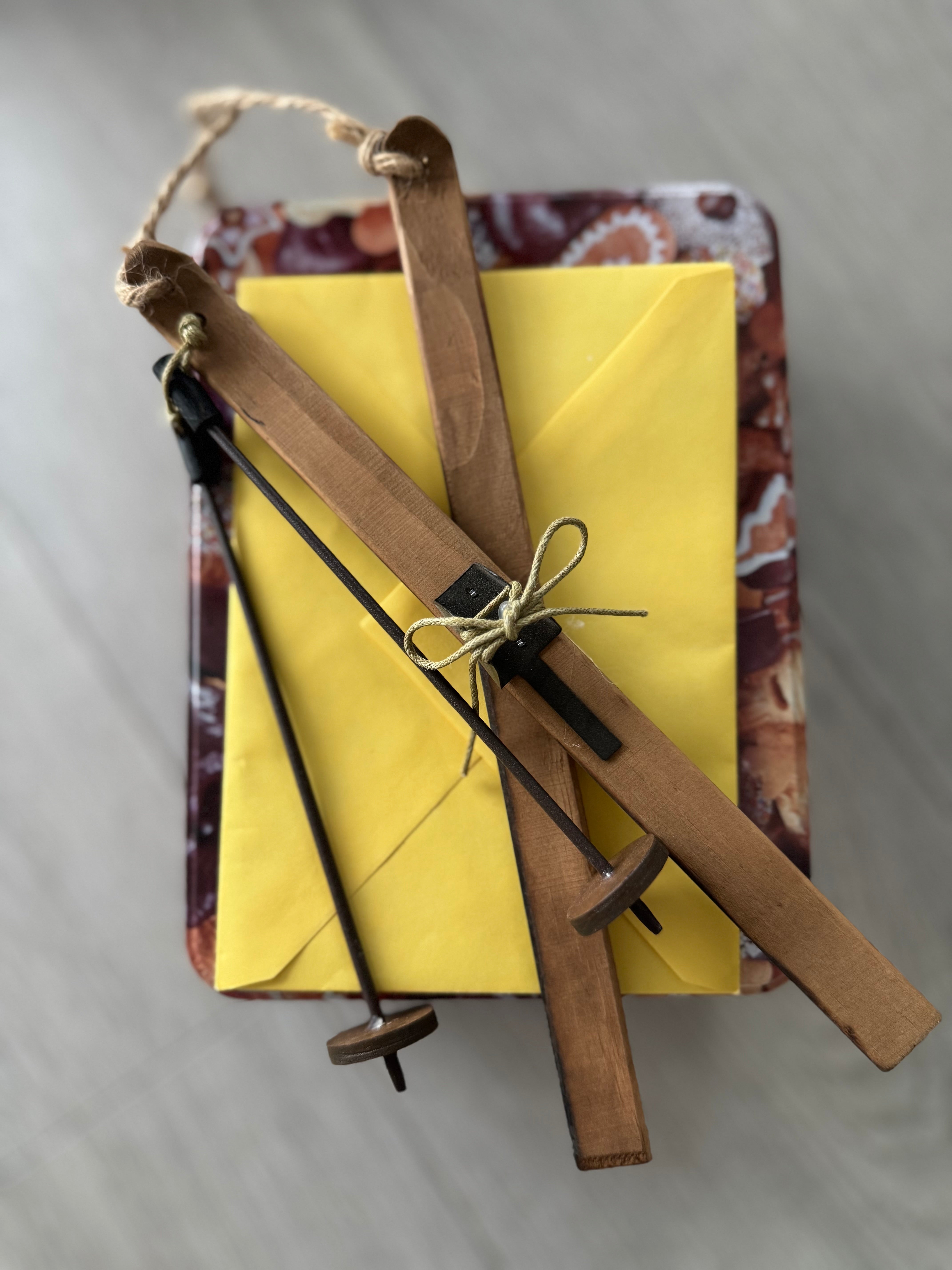 Small wooden tool set on a yellow envelope with a patterned background