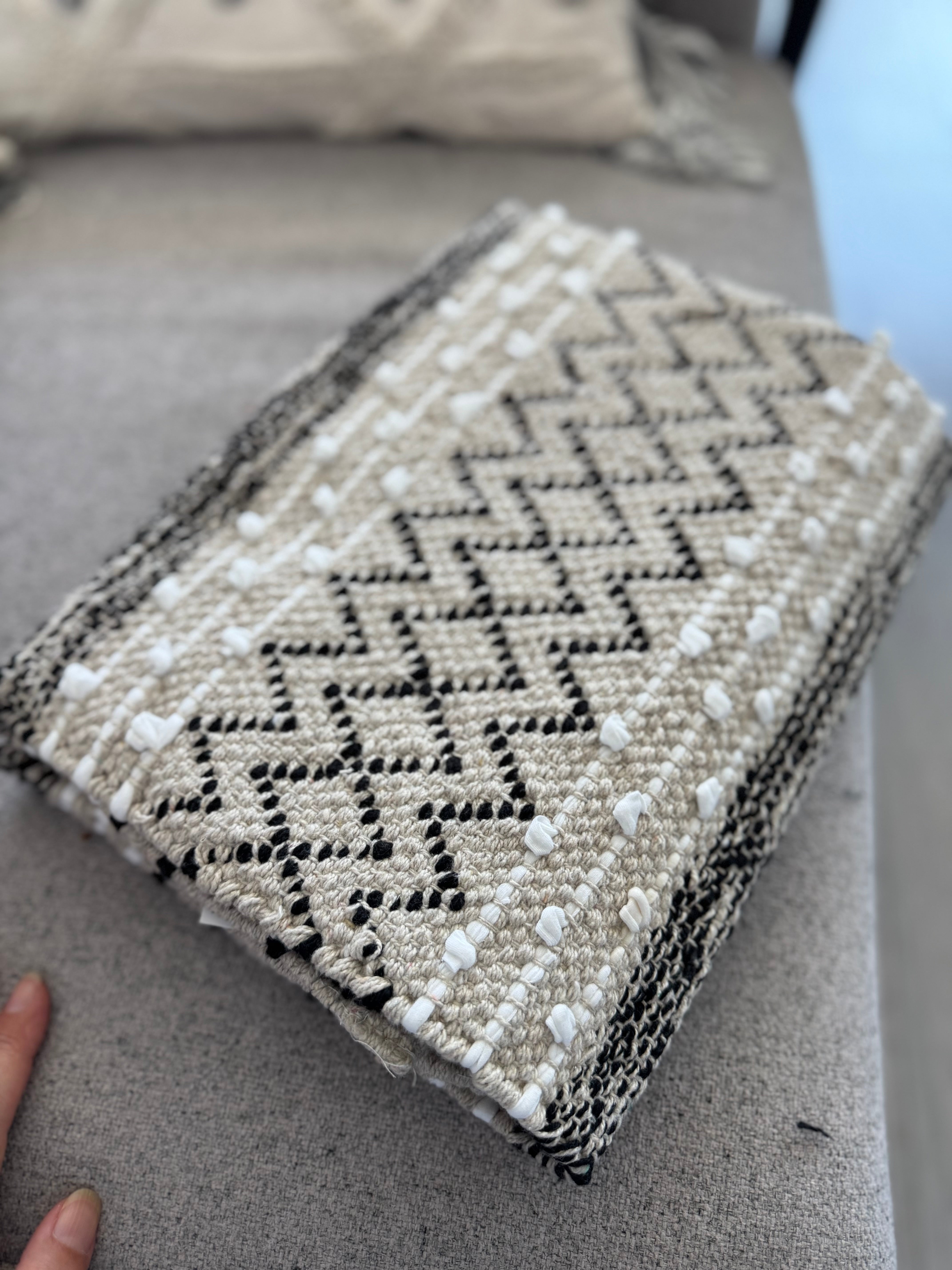 Textured fabric with geometric pattern on a gray surface