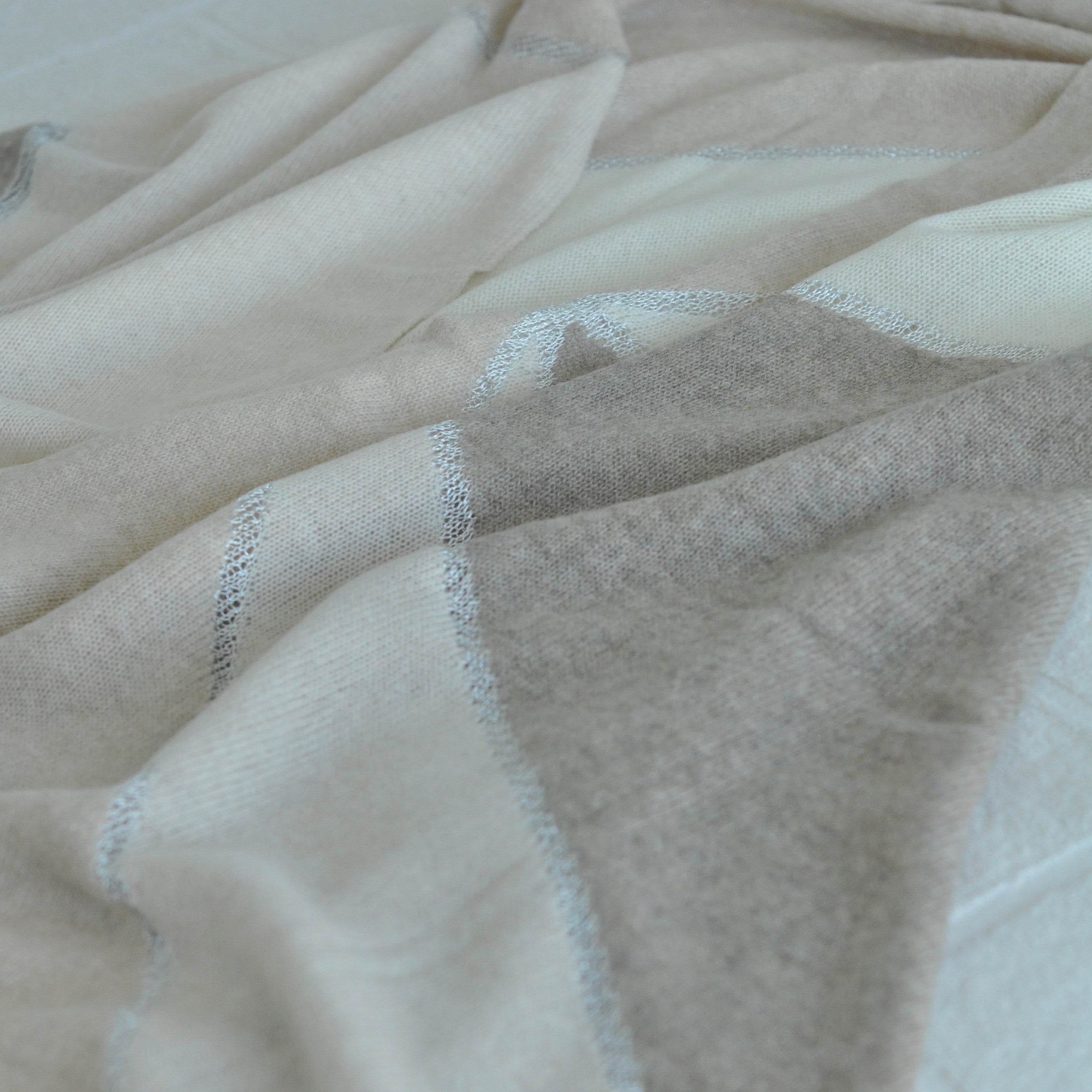 Close-up of beige fabric with subtle texture and stitching details
