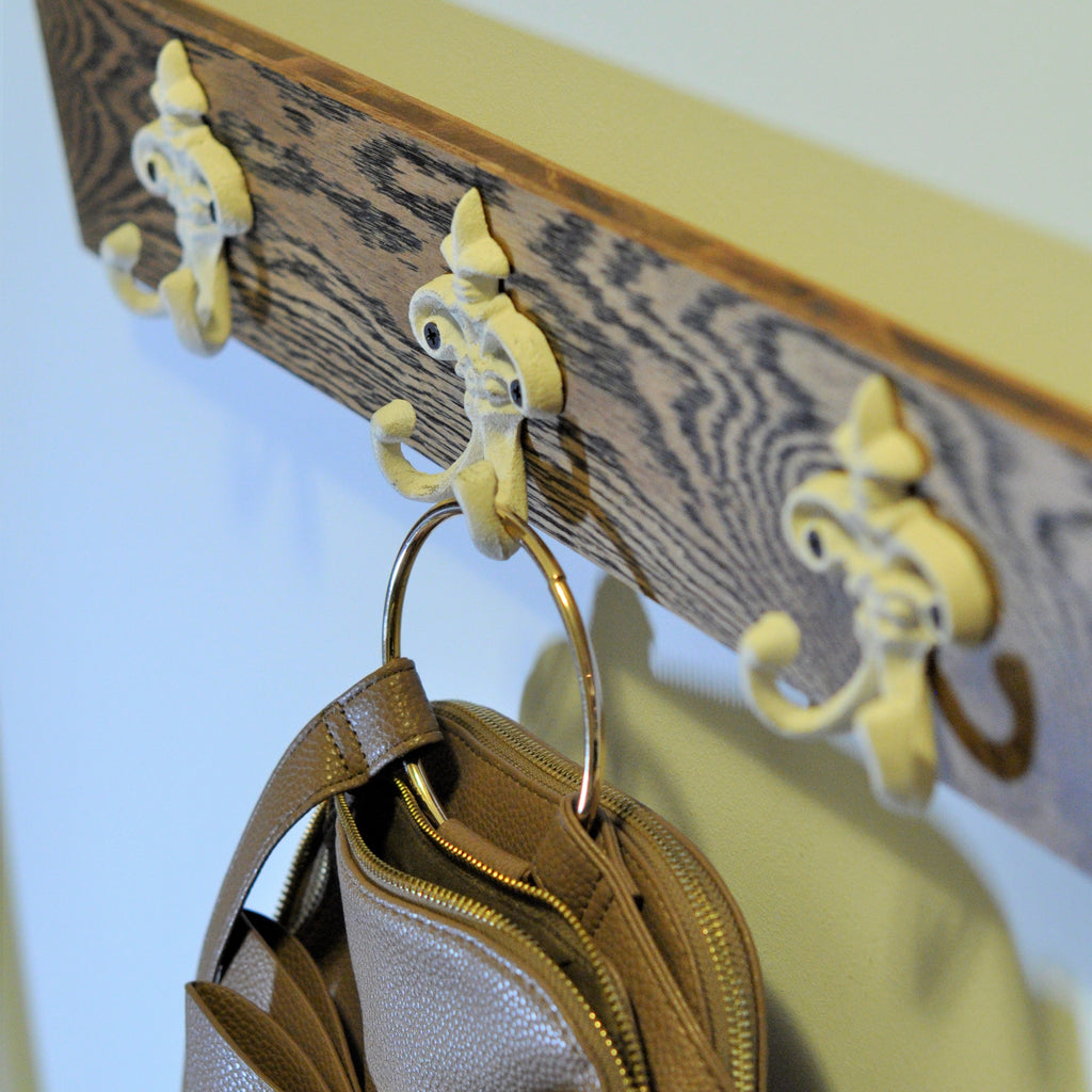 3 Vintage White Coat Hooks on a Wooden panel