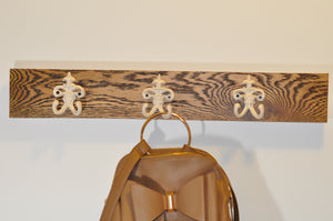 3 Vintage White Coat Hooks on a Wooden panel